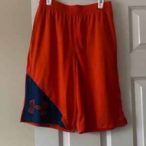 Seven pairs of Under Armour boys shorts in a variety of colors.